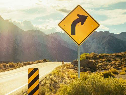 A sign indicating a curve in the road ahead icon