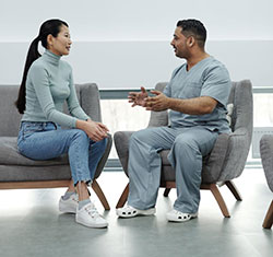 A health care professional talking with a patient