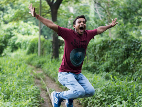 A man in a garden jumping for joy icon