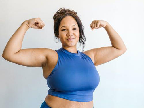A woman flexing her muscles icon