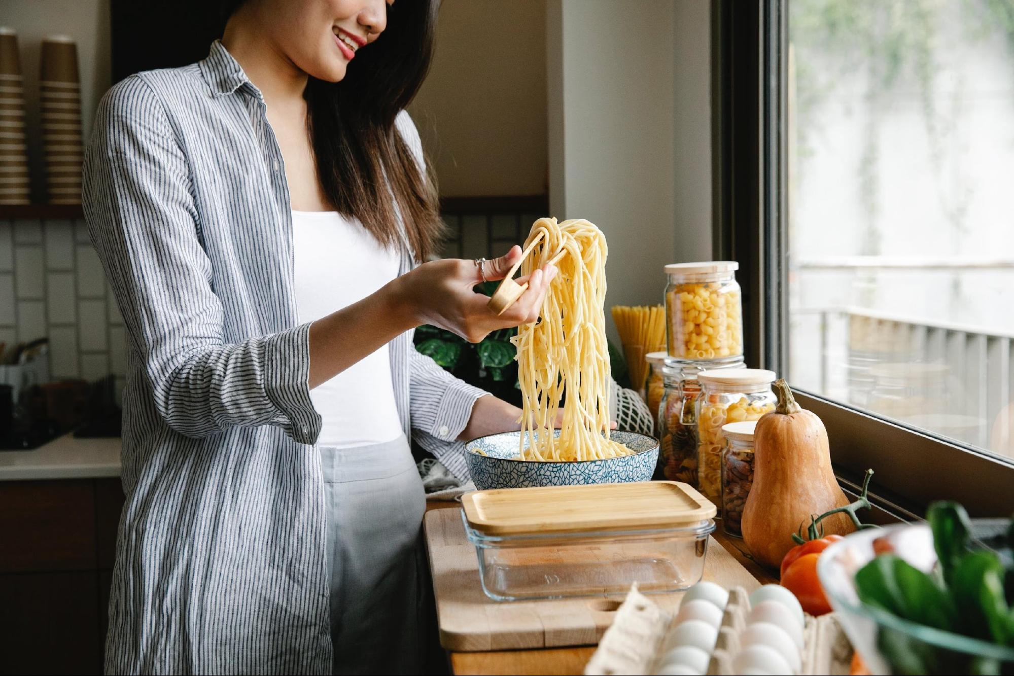 A woman cooking pasta icon