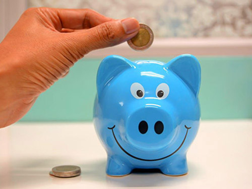 A hand dropping a coin into a small blue piggy bank icon