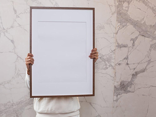 A person holding a blank frame icon