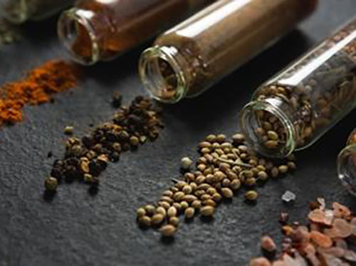 Jars of spices on their sides with spices coming out icon