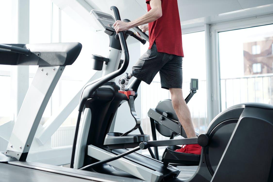 A person with a prosthetic leg using an elliptical machine