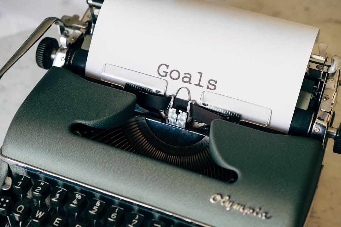 A typewriter with Goals typed on the paper in the machine icon