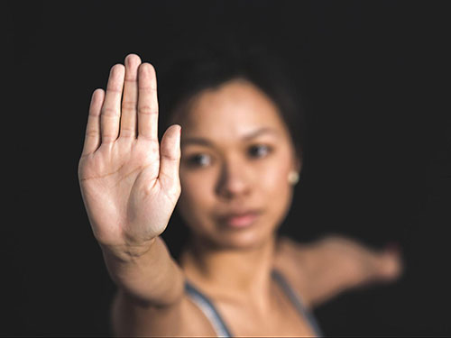 A woman doing a yoga pose with her hand in front of the camera icon